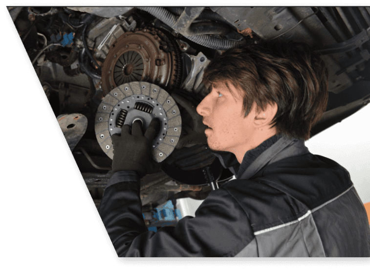 auto mechanic replacing a car clutch