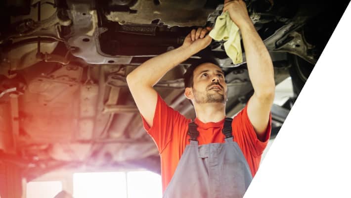car mechanic fixing a car under