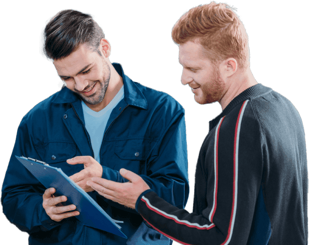 male car mechanics looking at a clipboard