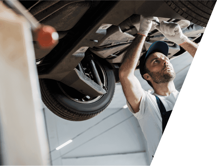 mechanic repairing a transfer case of car